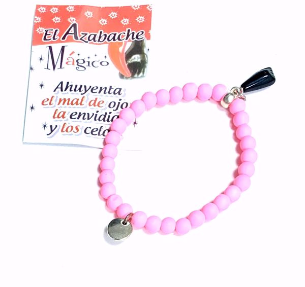 Imagen de Pulsera mano higa negra. Bolas de caucho rosa fosforito. Puño cerrado.